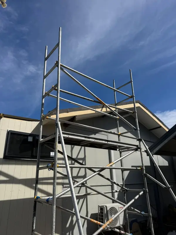Extension under construction, with scaffolding set up against the new roofline